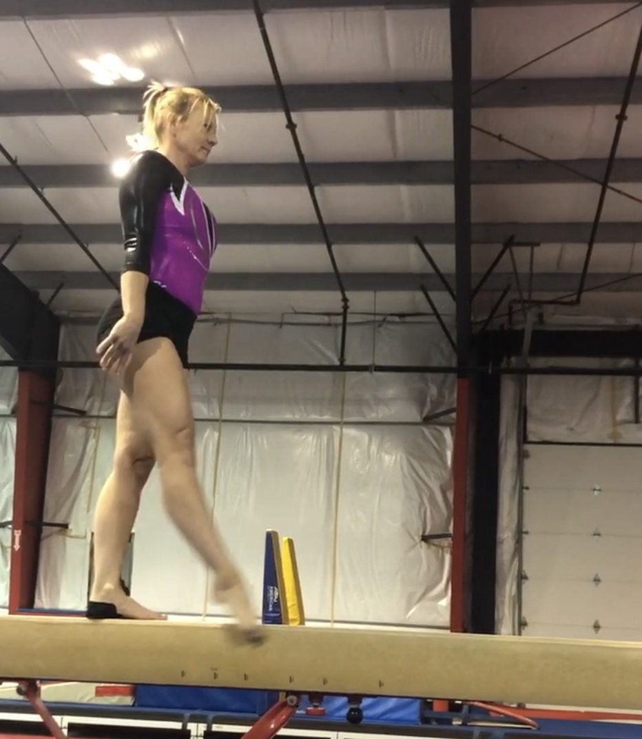Lori concentrating on her footing while training on the balance beam