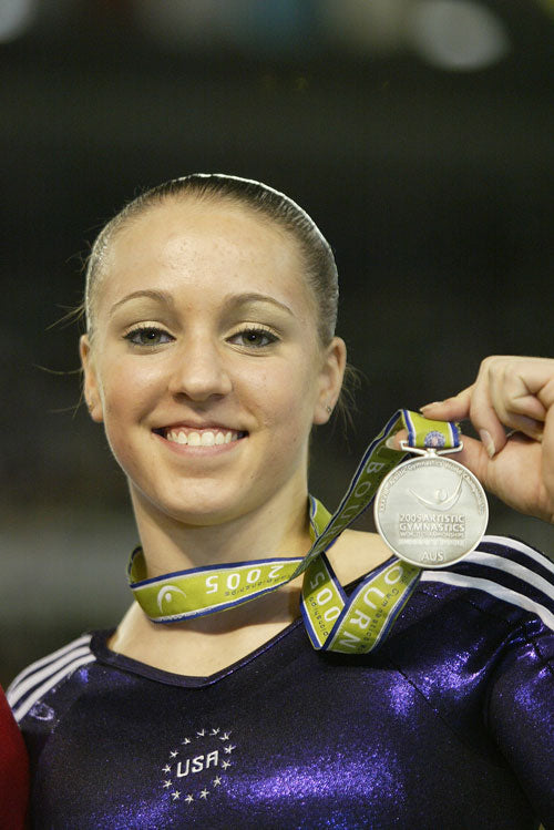 Chellsie Memmel holding a gymnastics medal