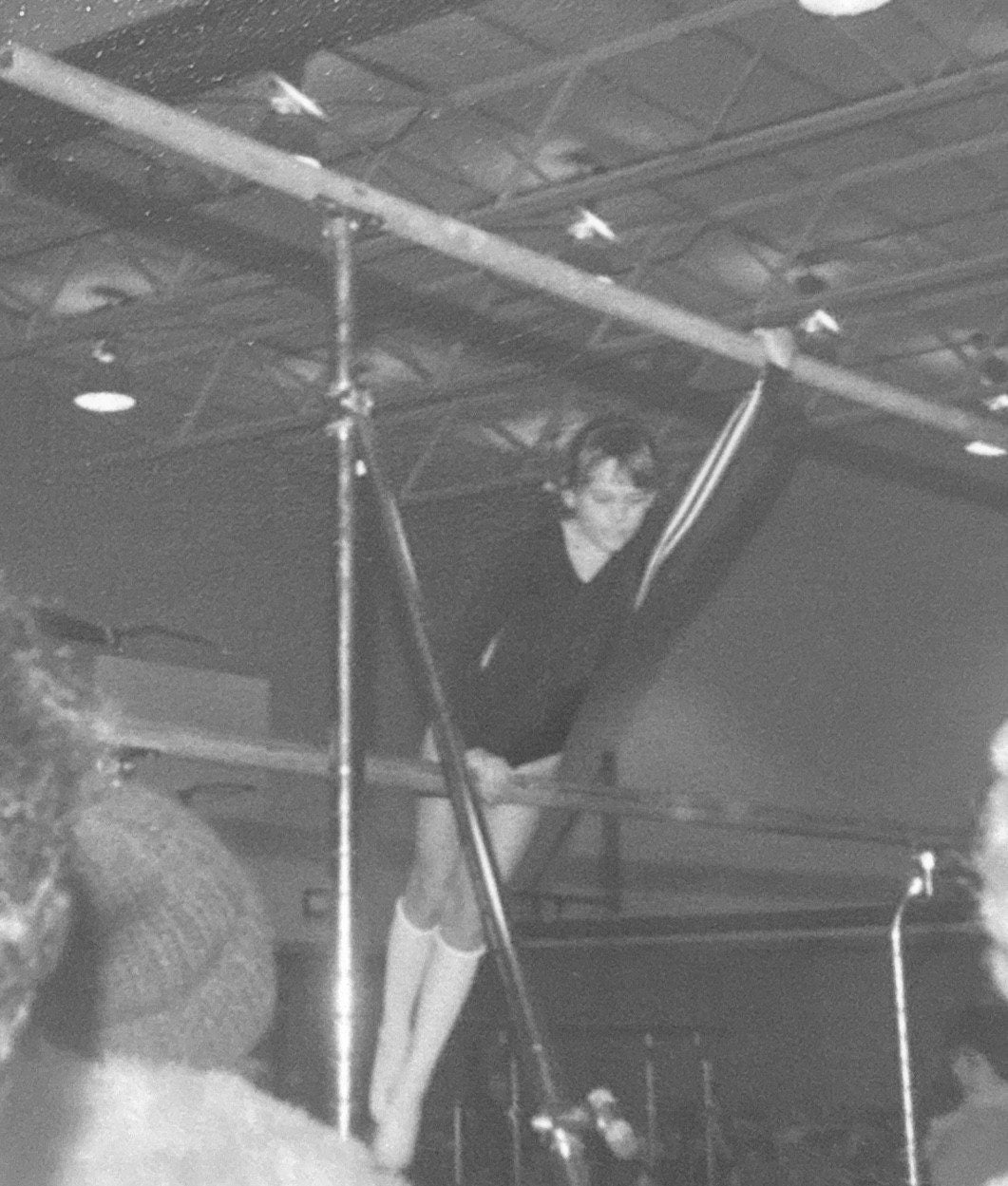 Lori competing on the uneven bars at age nine