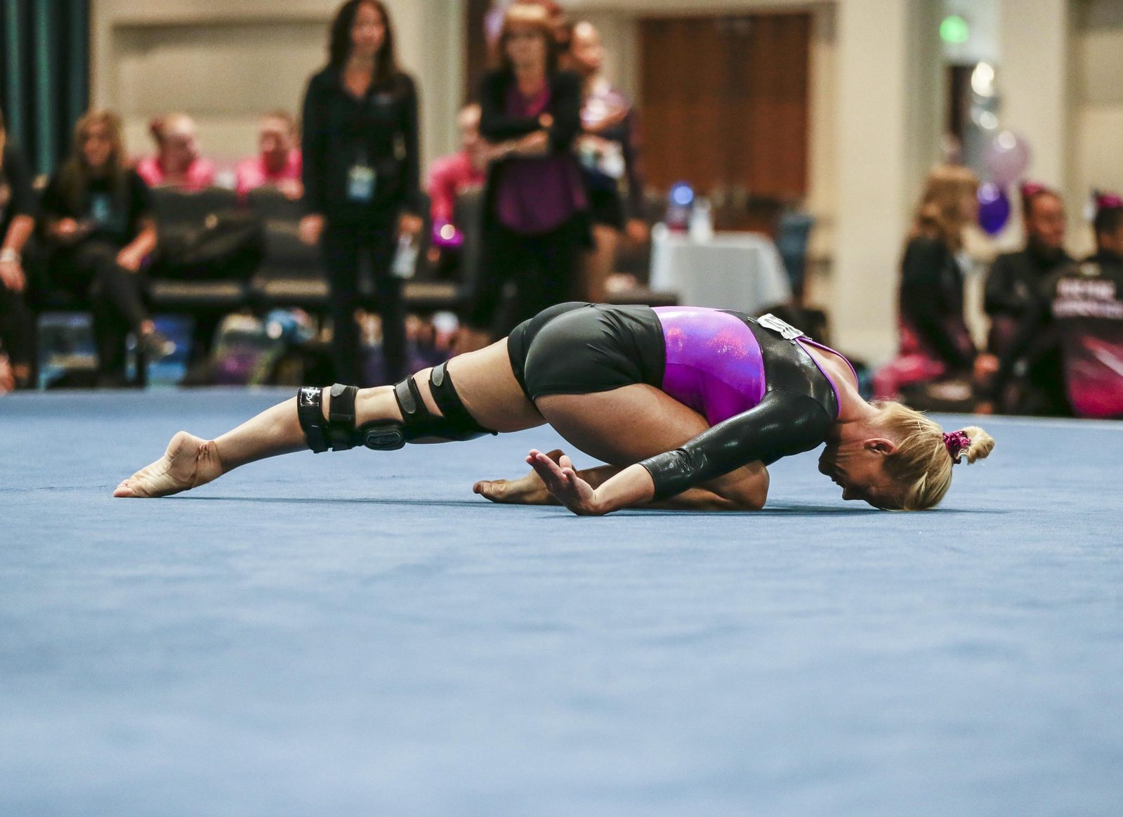 Lori Vollkommer finishing an expressive fold position during a competition floor routine